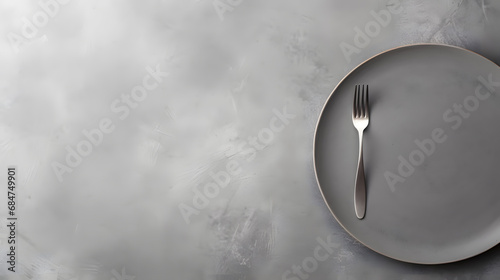 Dark plate with with golden cutlery on black background