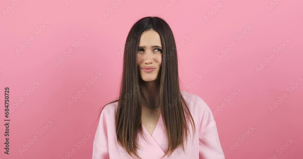 Perplexed dissatisfied woman looks frustrated at camera says I don't agree has puzzled face expression dressed casually isolated over pink background. Girl shake her head. No, deny. Perplexed dissatisfied woman looks frustrated at camera says I don't agree has puzzled face expression dressed casually isolated over pink background. Girl shake her head. No, deny.