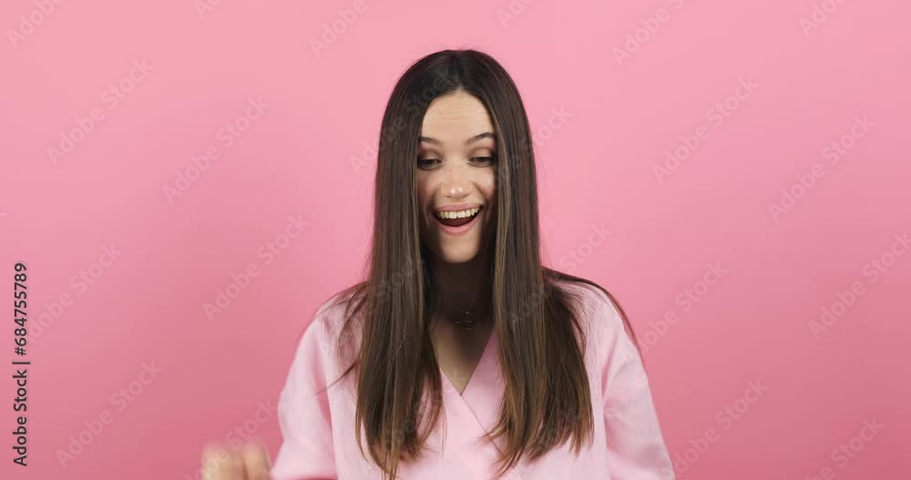 Look at advertisement! Teen stylish girl pointing down, saying to subscribe, showing place for commercial, promotional information below. Young woman isolated pink background. Look at down. Look at advertisement! Teen stylish girl pointing down, saying to subscribe, showing place for commercial, promotional information below. Young woman isolated pink background. Look at down.