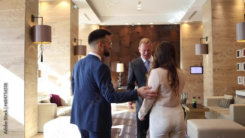 Businessman greeting his business partners at the lounge area of the hotel photo