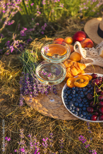 Picnic with wine in a lavender field. Selective focus.