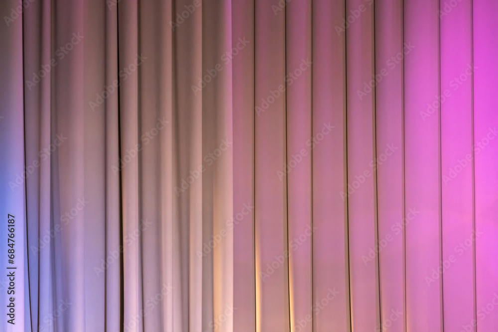 Obraz premium Closed theatrical curtain with pink spot lights, background texture