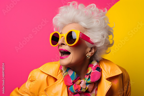 old lady in vintage sunglasses on a colourful background, in the style of energetic, pink, yellow and pink, modern, innovative, youthful