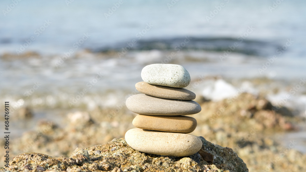 Stone cairn pyramid at seaside. Stack of balanced stones on the beach.
Stone cairn pyramid at seaside. Stack of balanced stones on the beach.