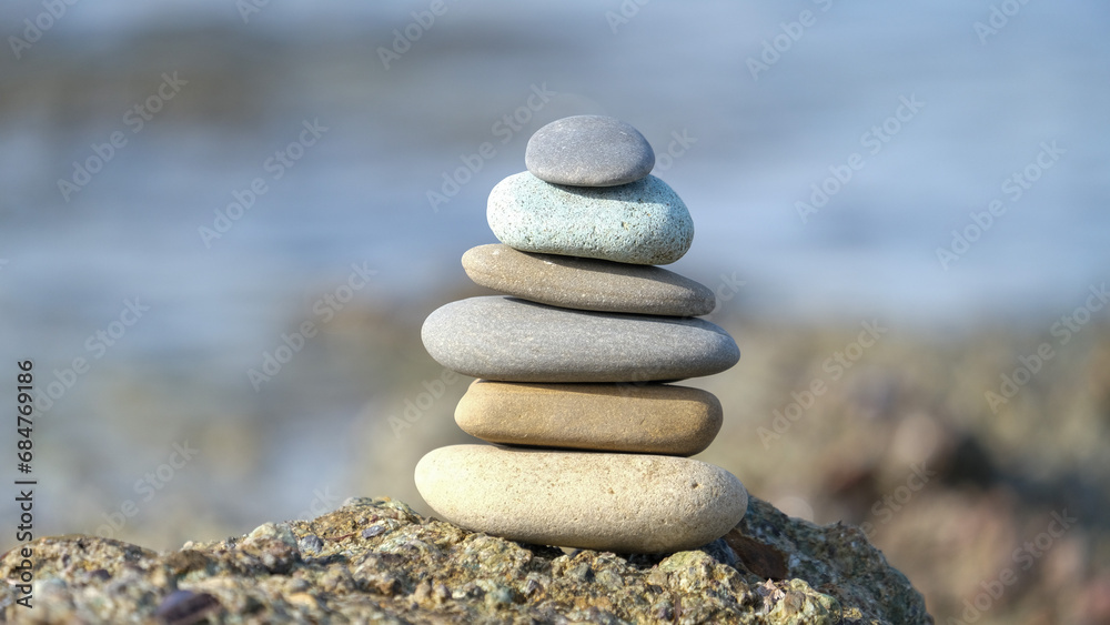 Stone cairn pyramid at seaside. Stack of balanced stones on the beach.
Stone cairn pyramid at seaside. Stack of balanced stones on the beach.