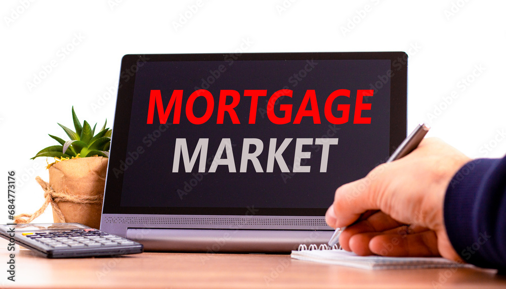 Mortgage market symbol. Concept words Mortgage market on beautiful black tablet. Beautiful white background. Calculator. Businessman hand. Business mortgage market concept. Copy space. Mortgage market symbol. Concept words Mortgage market on beautiful black tablet. Beautiful white background. Calculator. Businessman hand. Business mortgage market concept. Copy space.