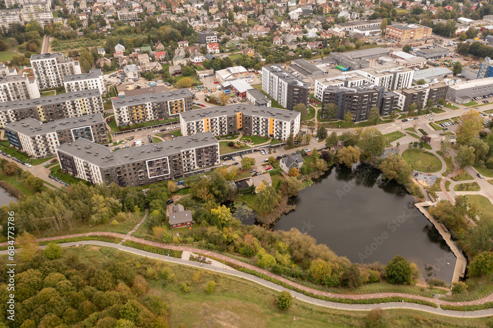 Drone photography of multistory apartment complex near a small lake Drone photography of multistory apartment complex near a small lake