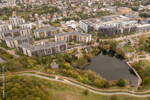 Drone photography of multistory apartment complex near a small lake