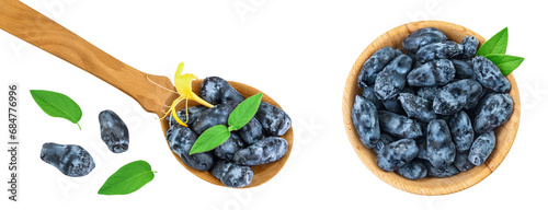 Fresh honeysuckle blue berry in wooden bowl and spoon isolated on white background with full depth of field. Top view. Flat lay photo