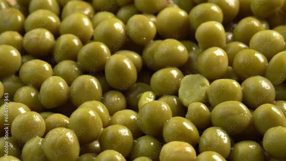 Canned green pea kernels rotate for cooking background side light. Marinated pickled sweet green peas Canned green pea kernels rotate for cooking background side light. Marinated pickled sweet green peas