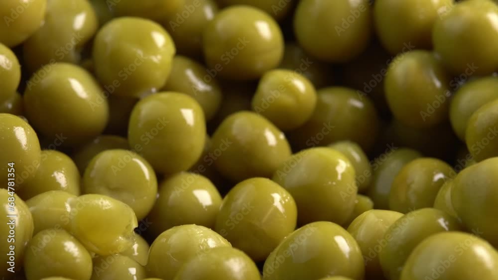 Spoon scoops canned green pea kernels for cooking side light. Marinated pickled sweet green peas Spoon scoops canned green pea kernels for cooking side light. Marinated pickled sweet green peas
