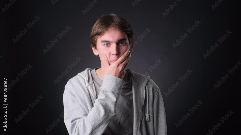 Astonished Man Exclaiming Wow on black Background Astonished Man Exclaiming Wow on black Background