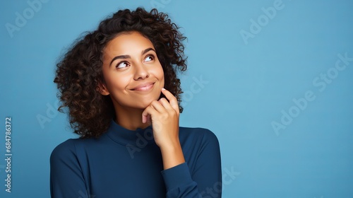 Youthful english lady disconnected on blue background thinking