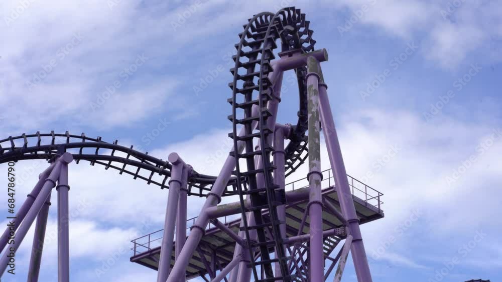 Roller coaster attraction. The amusement cart makes a circular loop, turns upside down. High quality 4k footage Roller coaster attraction. The amusement cart makes a circular loop, turns upside down. High quality 4k footage