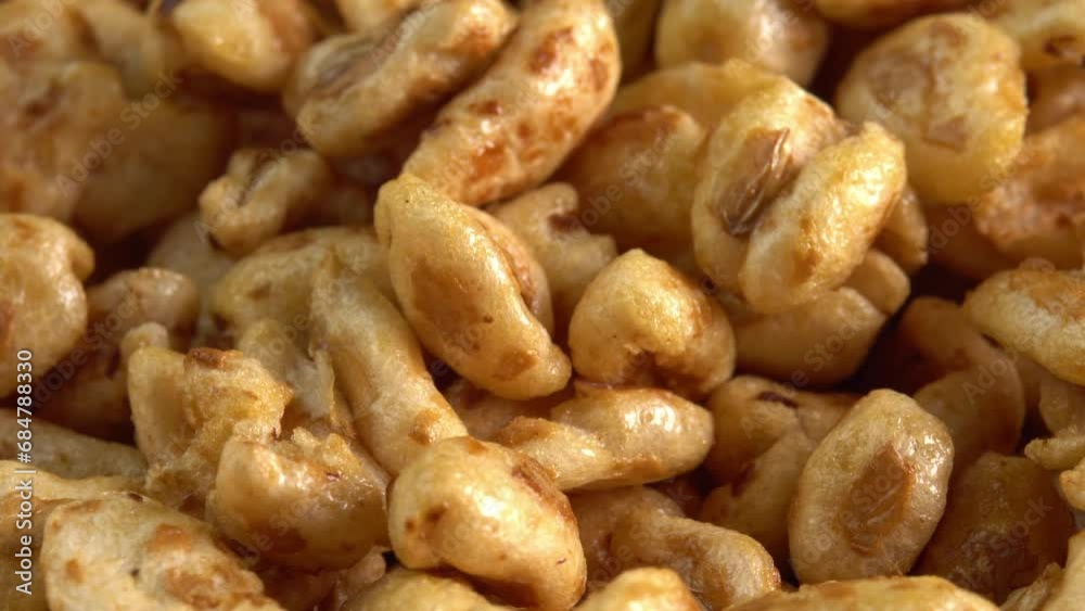 Roasted sweet puffed wheat rotate in macro like background. Dry breakfast to recharge your vital energy for the working day Roasted sweet puffed wheat rotate in macro like background. Dry breakfast to recharge your vital energy for the working day