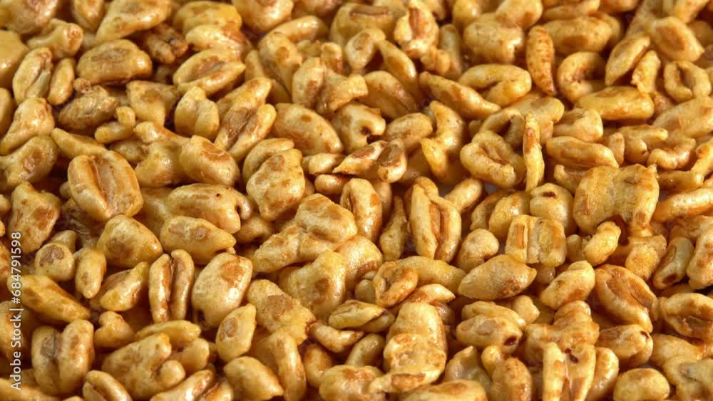 Roasted sweet puffed wheat background rotate top view. Dry breakfast to recharge your vital energy for the working day Roasted sweet puffed wheat background rotate top view. Dry breakfast to recharge your vital energy for the working day
