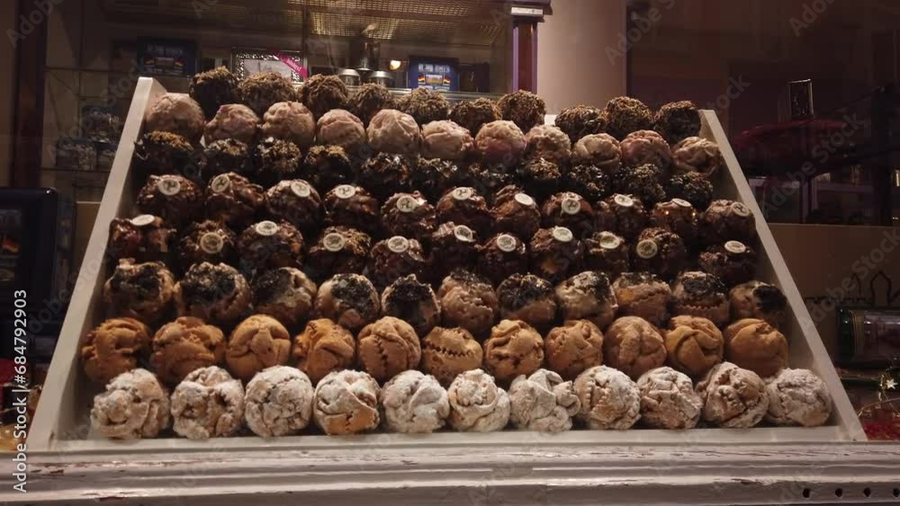 Fussen, Germany, December 6, 2022: Stefanie Diller Schneeballentraume traditional Snow Balls. Schneeball is a sweet pastry in many varieties with chocolate, pistachio, or sugar. Fussen, Germany, December 6, 2022: Stefanie Diller Schneeballentraume traditional Snow Balls. Schneeball is a sweet pastry in many varieties with chocolate, pistachio, or sugar.