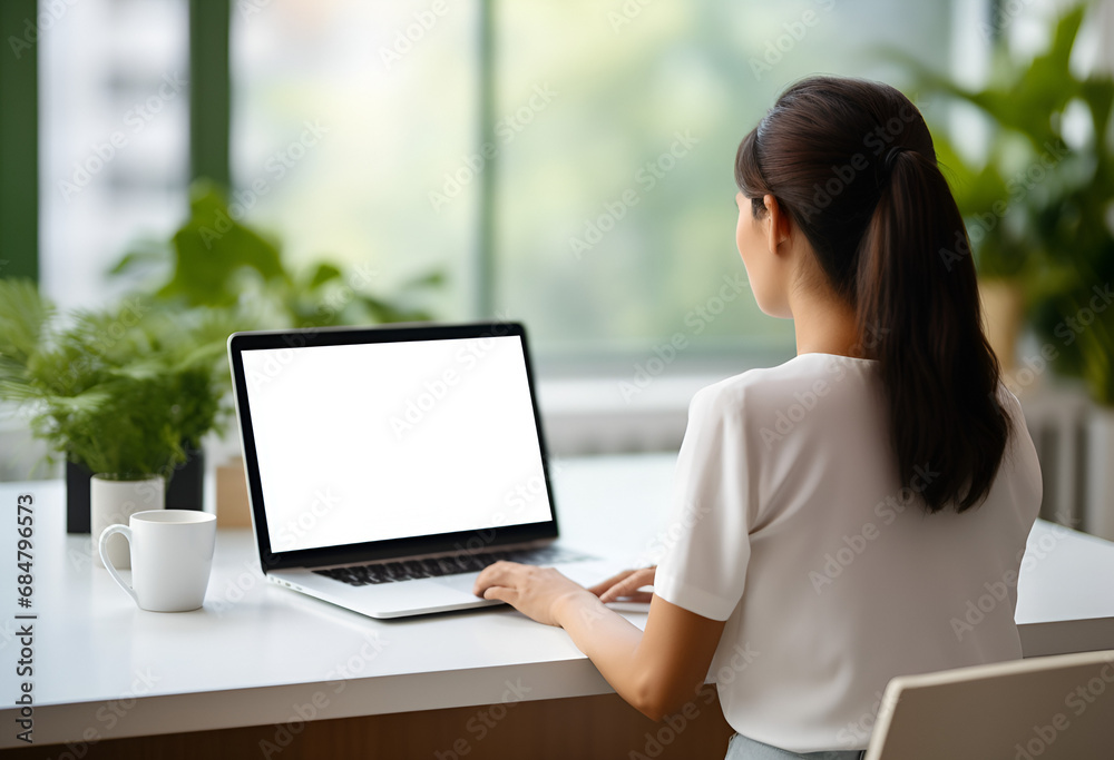Over shoulder closeup view of female student wearing glasses businesswoman looking at empty blank mockup screen for advertising, having virtual videoconference. Remote e learning online work concept. Over shoulder closeup view of female student wearing glasses businesswoman looking at empty blank mockup screen for advertising, having virtual videoconference. Remote e learning online work concept.