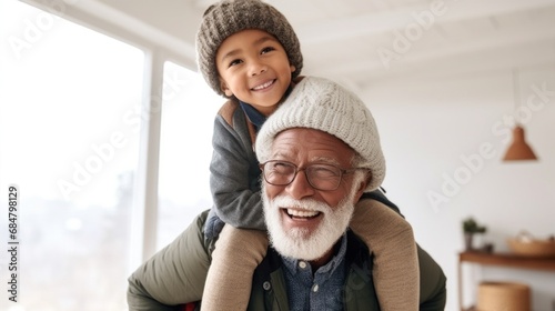 In a diverse home setting, a grandpa plays with his grandson.