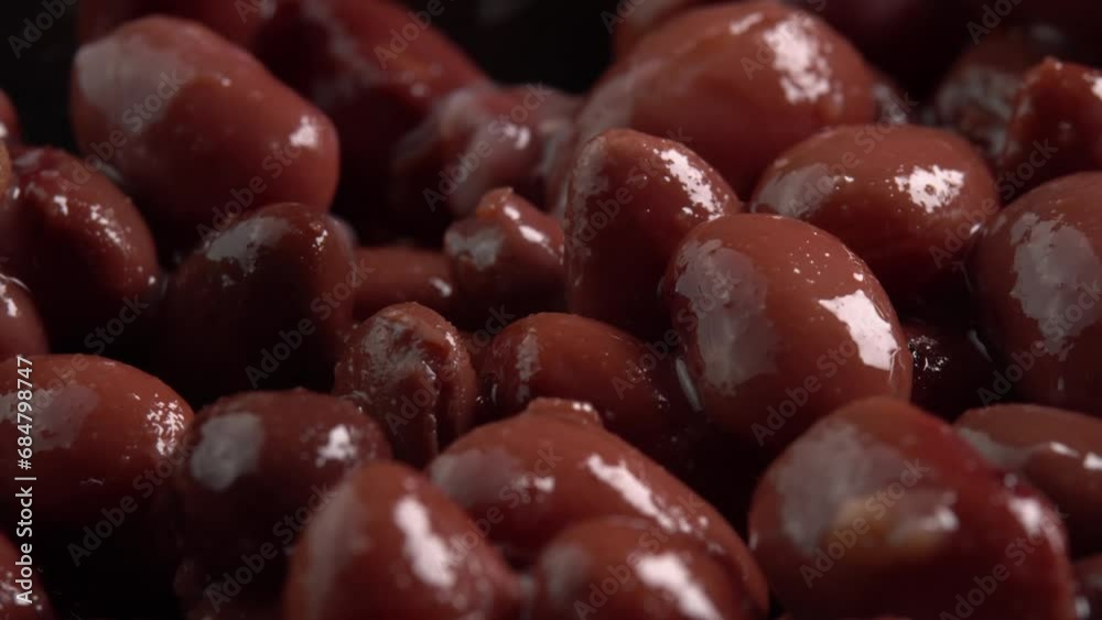 Canned red kidney beans rotating background low light. Organic steamed beans. Pickled beans for a Mexican dish Canned red kidney beans rotating background low light. Organic steamed beans. Pickled beans for a Mexican dish