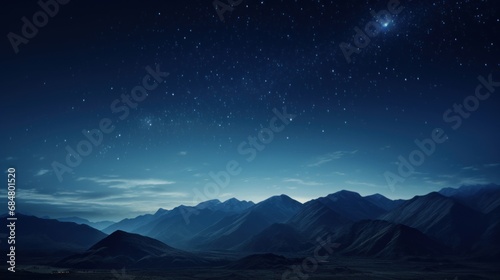  a view of a mountain range at night with a star in the sky over the top of the mountain range.
