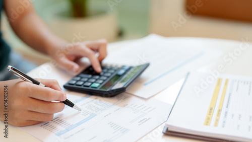 Close up of hand using calculator calculating personal finance for income and expenses..