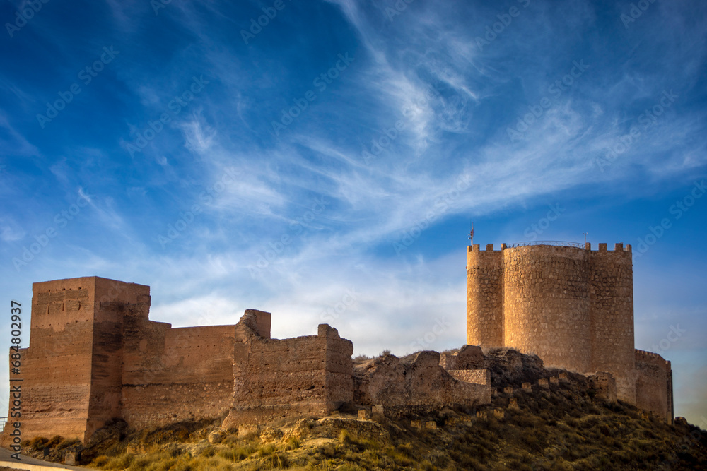 General view of Jumilla Castle, Murcia, Spain, with tower and medieval walls and blue sky