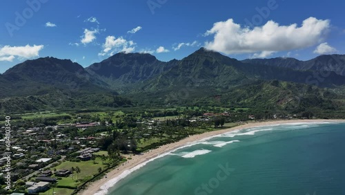 Aerial Kauai Hawaii Hanalei Bay recreation beach slide. Surfing and swimming ocean recreation. Bay cove for swimming, snorkel and surfing. Economy is tourism based. Tourist enjoy beach and warmth. photo