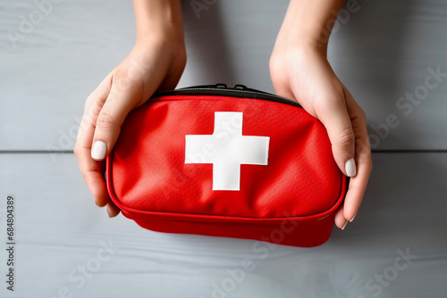 Red first aid medical kit bag with white cross. photo