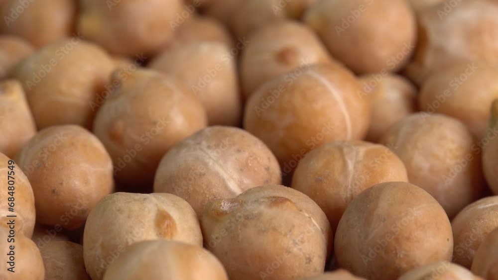 Dry chickpeas or dried garbanzo beans macro rotating background low light. Ingredient for falafel. Cicer arietinum Dry chickpeas or dried garbanzo beans macro rotating background low light. Ingredient for falafel. Cicer arietinum