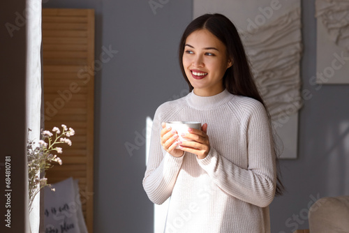 Young Asian woman with cup ...