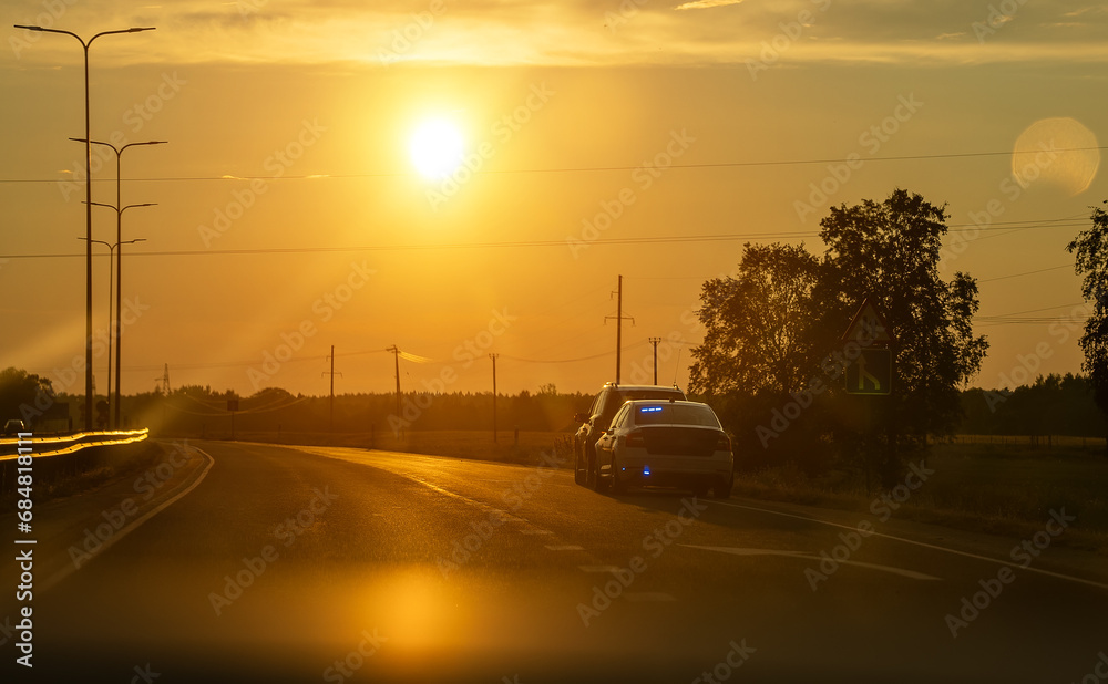 Police car stopped the offender at the edge of the road. Police car stopped the offender at the edge of the road.