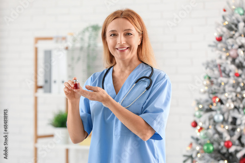 Female doctor holding vial ...