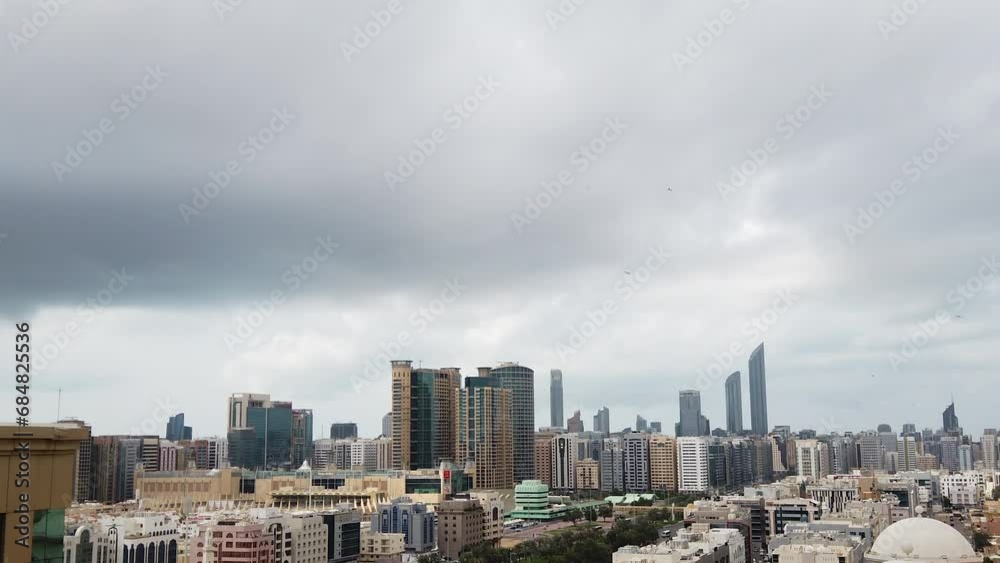 Aerial shot of modern city architecture | Abu Dhabi city skyline with beautiful winter clouds, time lapse | Downtown Aerial shot of modern city architecture | Abu Dhabi city skyline with beautiful winter clouds, time lapse | Downtown