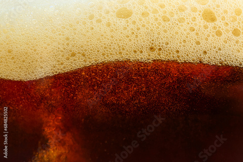 Foto Dark beer with foam as background
