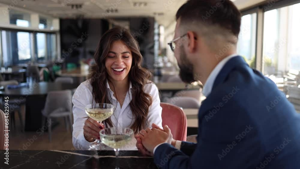Happy businesswoman and her business partner enjoying and having a drink together after a business conference at the hotel Happy businesswoman and her business partner enjoying and having a drink together after a business conference at the hotel