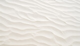 texture of close-up grooves produced by the wind that give the sand an appearance like small waves. The sand is light, slightly yellow in color