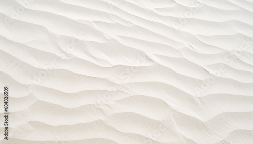 texture of close-up grooves produced by the wind that give the sand an appearance like small waves. The sand is light, slightly yellow in color photo