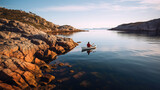 Kayaker appreciating view from tranquil rocky shore