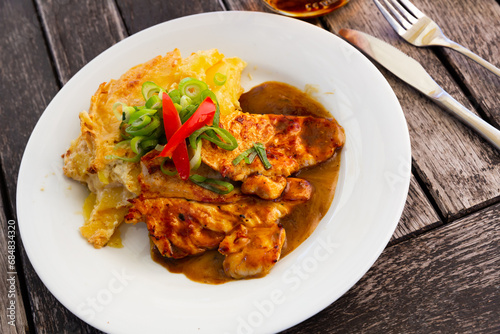 Fried chicken with baked potatoes and vegetables. High quality photo