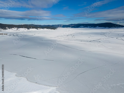 Aerial winter view of Batak Reservoir covered with ice, Bulgaria