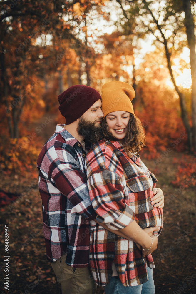 Happy couple wearing casual clothes walking together in an autumn forest. Happy couple wearing casual clothes walking together in an autumn forest.