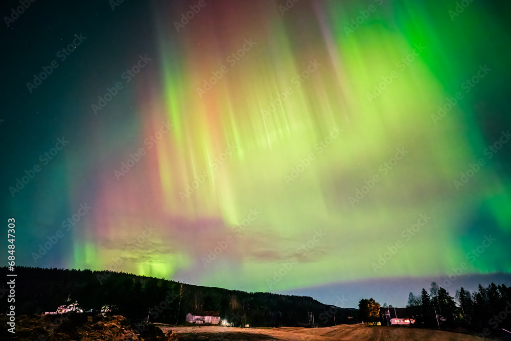 Colourful Aurora Borealis dancing over the sky