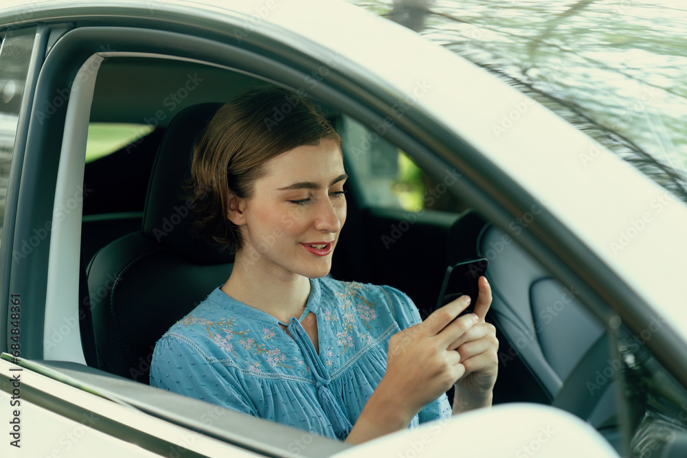 Beautiful woman in casual wear sitting on driver seat portrait. Cute girl driving a car concept with happy expression and pleasant smiling. Young woman with car road trip lifestyle. Perpetual