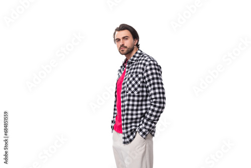 young macho brunet caucasian man with stylish haircut and beard on white background. people lifestyle concept