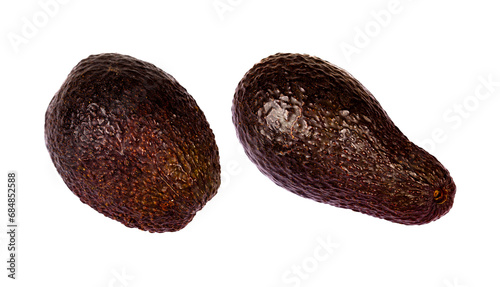 Two whole dark colored brown ripe brown avocados, ripe avocado fruit ready to eat, objects isolated on white background, cut out, nobody. Two brown avocado fruits up close, assets, design elements photo