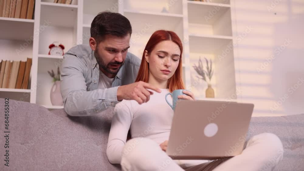 Exhausted young red haired woman girlfriend get struggles while working on laptop computer and her boyfriend appears with cup of coffee or tea to cheer her up and hug tightly at home Family support Exhausted young red haired woman girlfriend get struggles while working on laptop computer and her boyfriend appears with cup of coffee or tea to cheer her up and hug tightly at home Family support