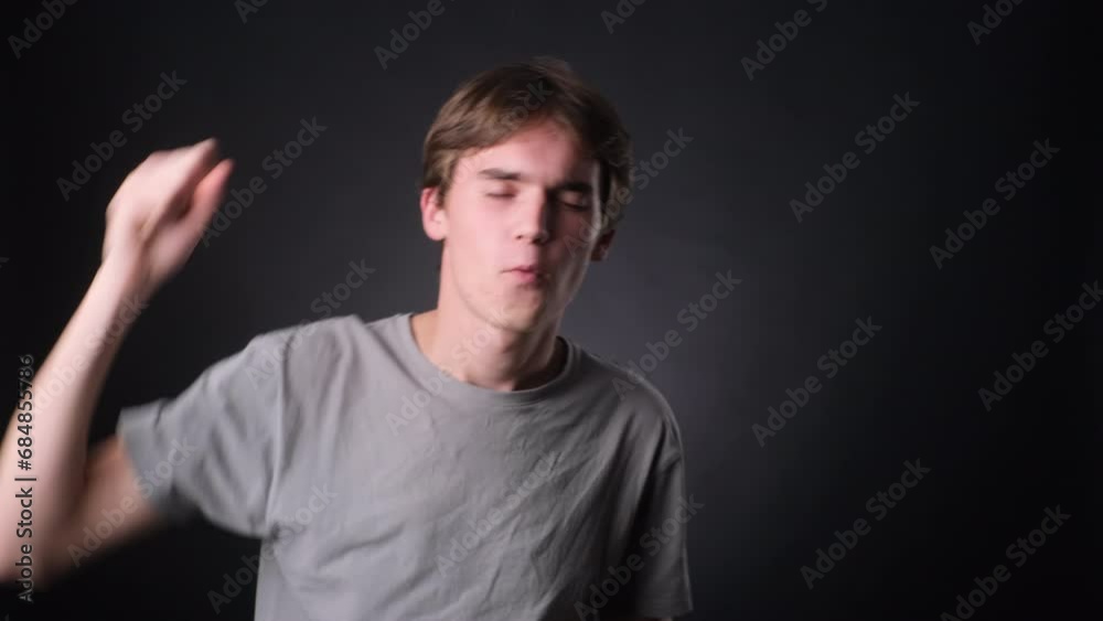 Positive Caucasian Man Dancing on black Background Positive Caucasian Man Dancing on black Background