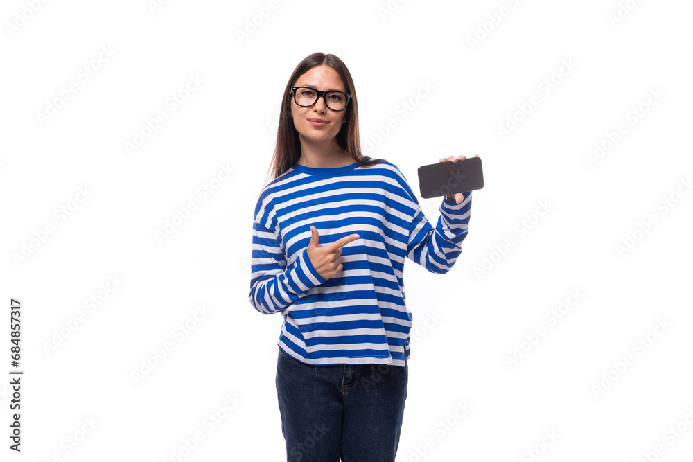 positive smiling young brunette woman in glasses holding smartphone horizontally with screen mockup for advertising insertion positive smiling young brunette woman in glasses holding smartphone horizontally with screen mockup for advertising insertion
