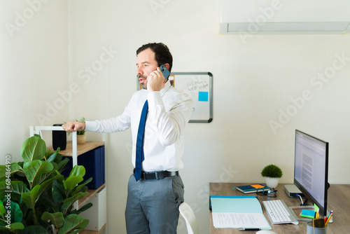 Lawyer boss at the office talking on the phone with a client